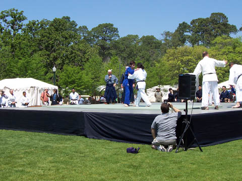 Houston Budokan group performs Judo (developed from the principles of jujitsu, a weaponless system of self-defense) moves for the audience.